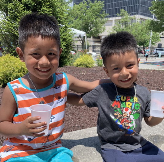 Two kids drinking water